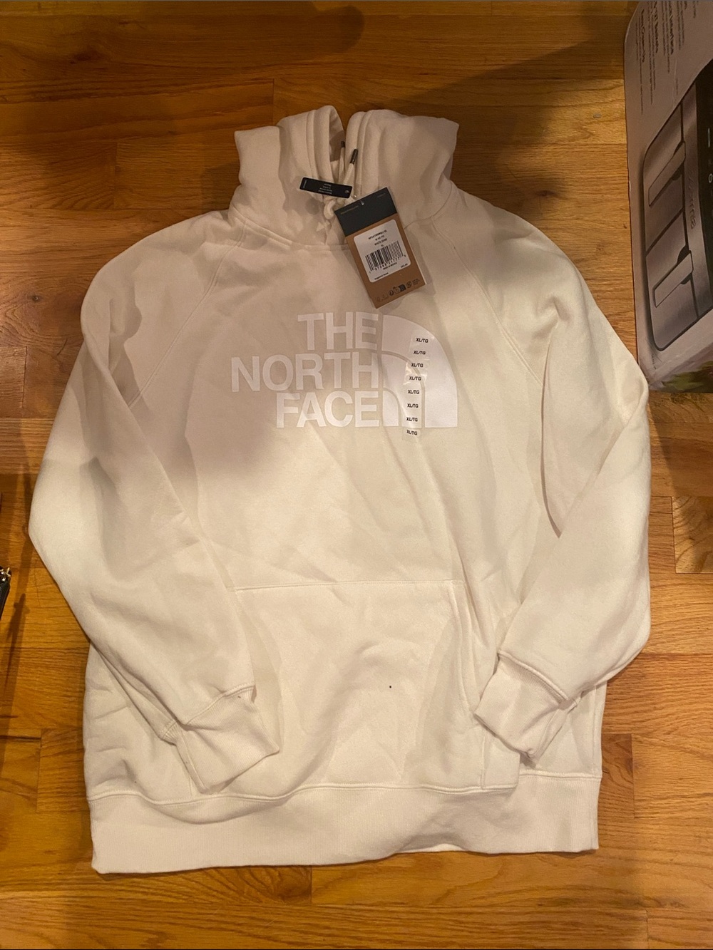 The North Face Cream Pullover Hoodie with Logo.